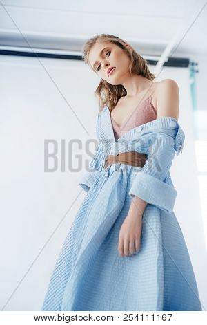 Portrait Of Beautiful Young Woman With Makeup In Fashion Blue Clothes