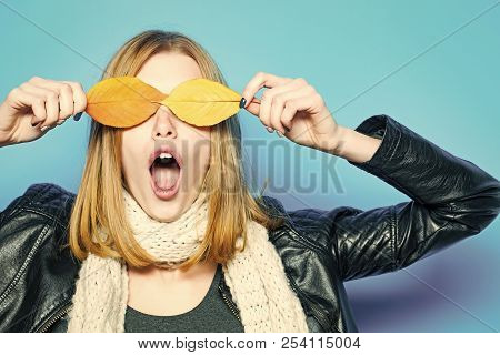 Woman With Autumn Leaves As Glasses In Leather Jacket. Surprised Model With Stylish Hair In Scarf. G