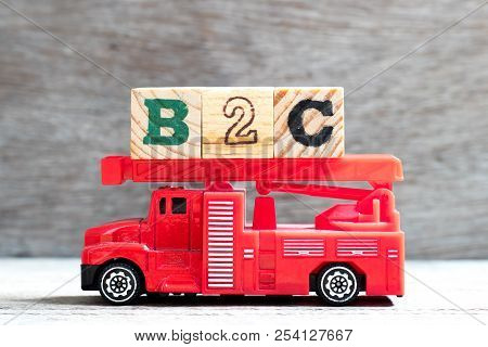Toy Fire Ladder Truck Hold Letter Block In Word B2c (abbreviation Of Business To Consumer) On Wood B