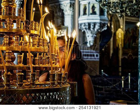 Athens, Greece - June 30, 2018. Parishioner Light Candles In The Nave Of The Metropolitan Cathedral 
