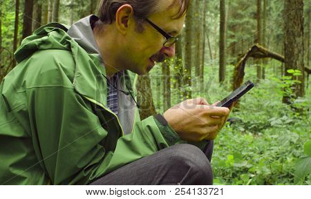 The Ecologist In A Forest With Smart Phone