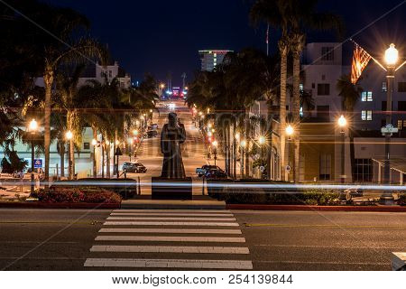 Morning Vehicles Lights Streaking Past Junipero Serra Statue Overlooking Downtown Ventura, Californi
