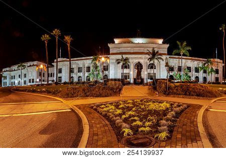 Panoramic View Of Ventura City Hall Building Lit Up At Night With Landscaping And Junipero Serra Sta