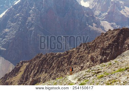 Wanderlust time. Man hiking in beautiful Fann mountains in Pamir, Tajikistan. Central Asia.