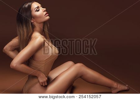 Sensual Brunette Woman With Ideal Tan Body.