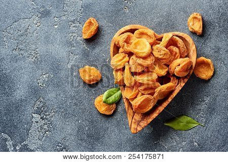Dried Apricots On Gray Concrete Background With Copy Space. Top View.