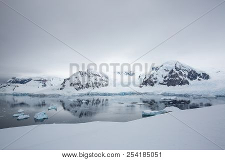 Ice In The Antarctica With Iceberg In The Ocean