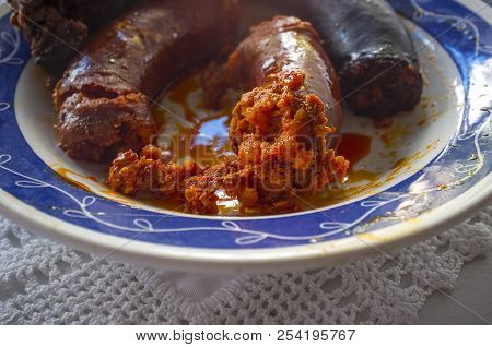 Red Chorizo And Black Sausage Morcilla Just Boiled On A Plate Over Knitting Cloth. Closeup
