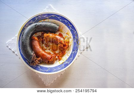 Red Chorizo And Black Sausage Morcilla Just Boiled On A Plate Over Knitting Cloth. Closeup