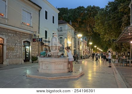 TREBINJE, BOSNIA AND HERZEGOVINA - JULY 08, 2083: drink water fountain of Goiko Shishkovich in pedestrian zone at night