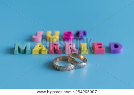 Multicolored Inscription Just Married On A Blue Background