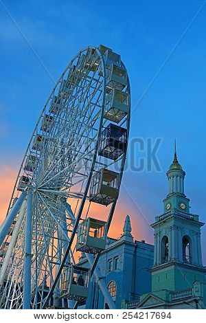 The Ferris Wheel In The Historical Part Of Kyiv On The Kontraktova Square On Podol In The Evening, K