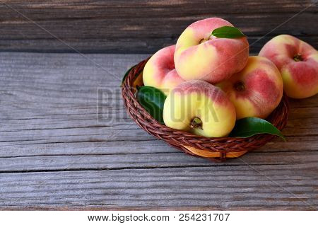 Chinese Flat Donut Peaches In The Basket On On Old Wooden Table Also Known As Saturn Donut, Doughnut
