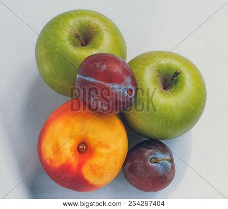 Set Of Fruits Isolated On White Background: Two Apples, Two Plums, One Nectarine