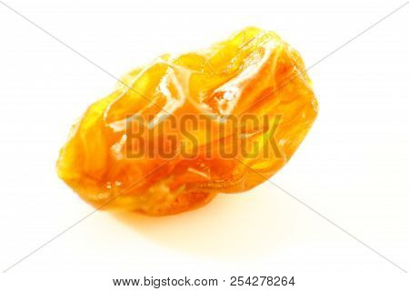 Golden Raisin In White Background / A Raisin Is A Dried Grape. Raisins Are Produced In Many Regions 