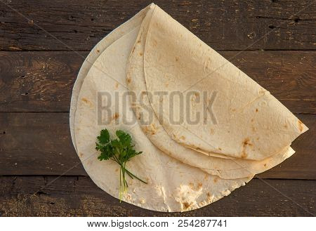 Armenian Flat Bread Lavash. Pita Bread On Black Wood Background. Copy Space. Top View Or Flat-lay.