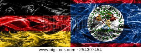 Germany Vs Belize Smoke Flags Placed Side By Side. German And Belize Flag Together