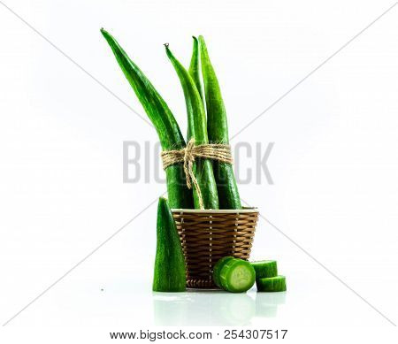 Snake Gourd Fresh In Wooden Baket Isolated On White Background