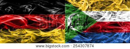 Germany Vs Comoros Smoke Flags Placed Side By Side. German And Comoros Flag Together