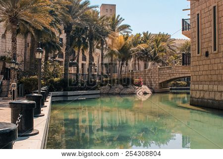 Madinat Jumeirah Is An Area Called Dubai Venice. Channels With Water Around Which Are Houses And Pal