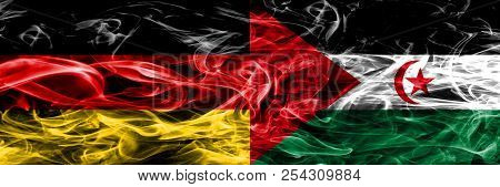 Germany Vs Sahrawi Smoke Flags Placed Side By Side. German And Sahrawi Flag Together
