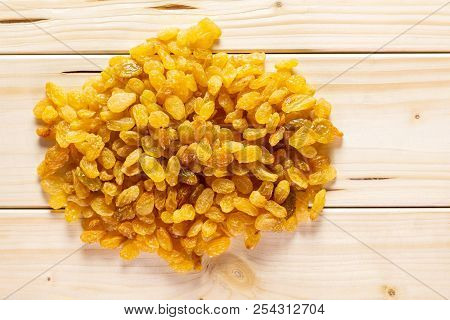 Lot Of Whole Dry Golden Raisins Sultana Variety Stack Flatlay On Natural Wood