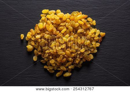 Lot Of Whole Dry Golden Raisins Sultana Variety Stack Flatlay On Grey Stone