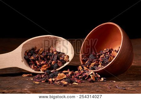 Raspberry Tea In Brown Clay Bowl. Wooden Background. Copy Space.