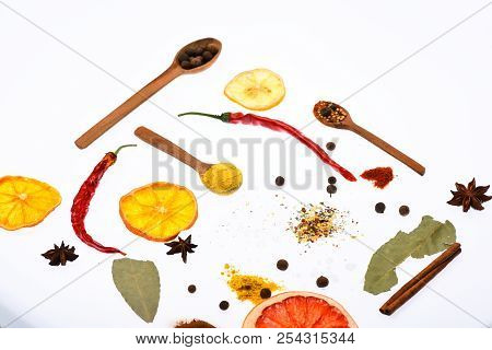 Culinary Art Concept. Spoons With Kitchen Herbs, Star Anise And Bay Leaf On White Background. Compos