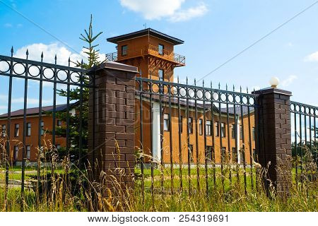 Fire Tower. Ancient Central Fire Tower And Fire Station Building. Metal Fence.