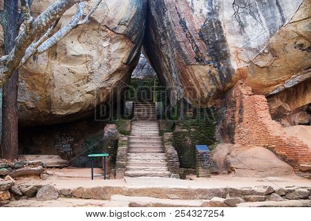 Stairs Between Some Huge Orange Brown Rocks In Sigiriya, Sri Lanka