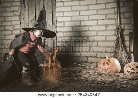 Little Witch Making A Magic Potion At Halloween Night. Horror.