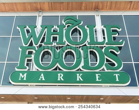 Close-up Logo Of Whole Foods Market At Store Entrance Facade