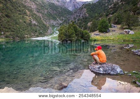 Wanderlust time. Man hiking in beautiful Fann mountains in Pamir, Tajikistan. Central Asia.