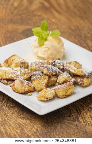 Austrian Kaiserschmarrn With Ice On Dark Wood