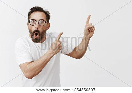 Studio Shot Of Shocked And Surprised Impressed Man With Beard And Moustache In Trendy Black Glasses,