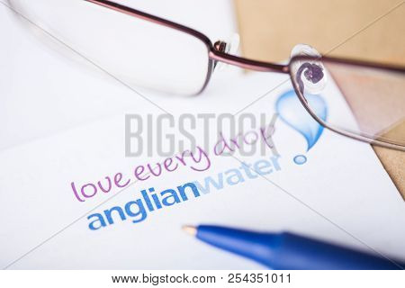 London, Uk - August 18, 2018: Anglian Water Supplier Logo On Paper With Glasses And Pen.