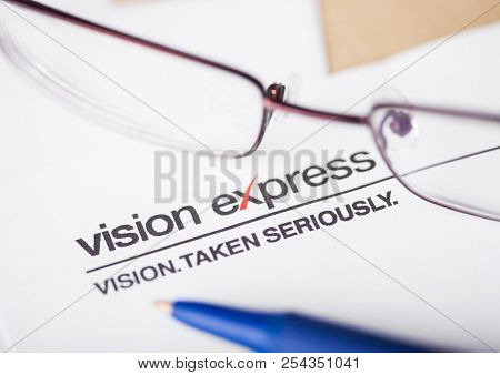 London, Uk - August 18, 2018: Vision Express Logo On Papre With Glasses And Pen.