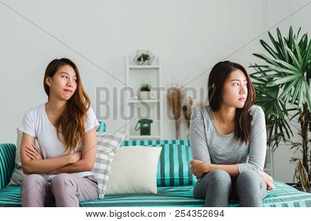 Young Asian Lesbian Couple Argue And Turn Their Back To Each Other In The Period Of Sad In The Bedro