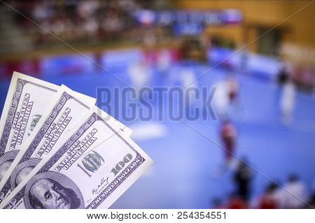 Money Dollars On The Background Of A Tv On Which Show Handball, Sports Betting, Money Dollars And Ha