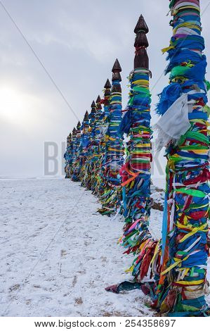 Wooden Ritual Pillars With Colorful Ribbons On Cape Burkhan, Lake Baikal, Olkhon Island, Siberia, Ru