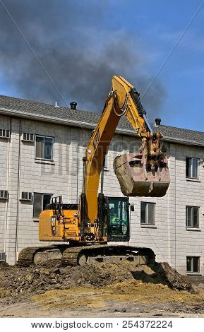 Fargo North Dakota,  August 7, 2018: Founded In 1925, The 336f Cat Excavator Moving A Scoop Of Earth
