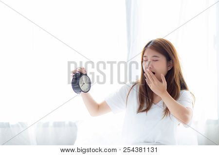 Beautiful Young Asian Woman Yawn Wake Up In Morning Annoyed Alarm Clock Holding Hand, Standing Hurry