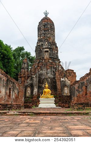 Beautiful Golden Buddha Image In Front Of Old Pagoda In Ancient Ruined Buddhist Temple In Ayutthya, 