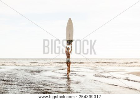 Young Surfer Girl In Sexy White Bikini And Short Denim Shorts Stay In River And Pose With Surf Short