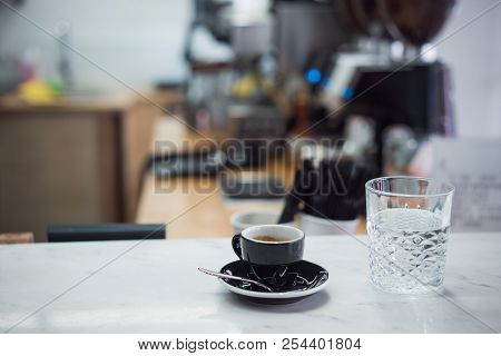 Coffee Mug And A Glass Of Water On A Table