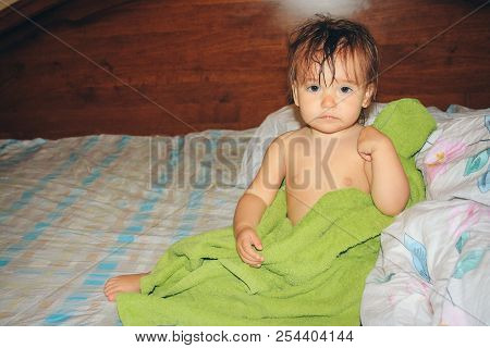 A Child With Wet Hair Wrapped In A Green Towel. Healthy Lifestyle