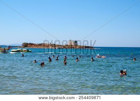 Malia. Crete, Greece - July 1, 2018: People Are Resting On A Sunny Day At The Beach In Malia, Crete,