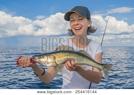 Happy Fisher Woman With Zander Fish Trophy At The Boat