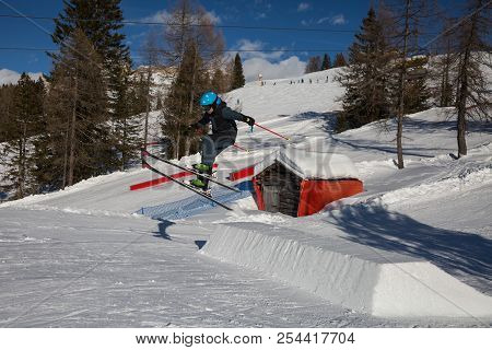 Skier In Action: Ski Jumping In The Mountain Snowpark.